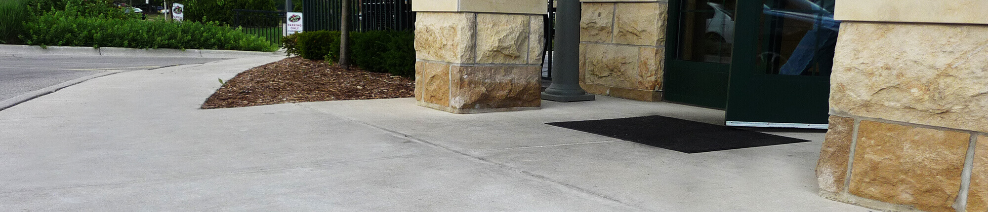 Fresh concrete installation in front of office building.
