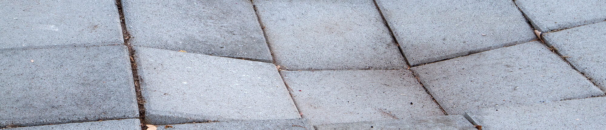 Sunken concrete sidewalk tiles