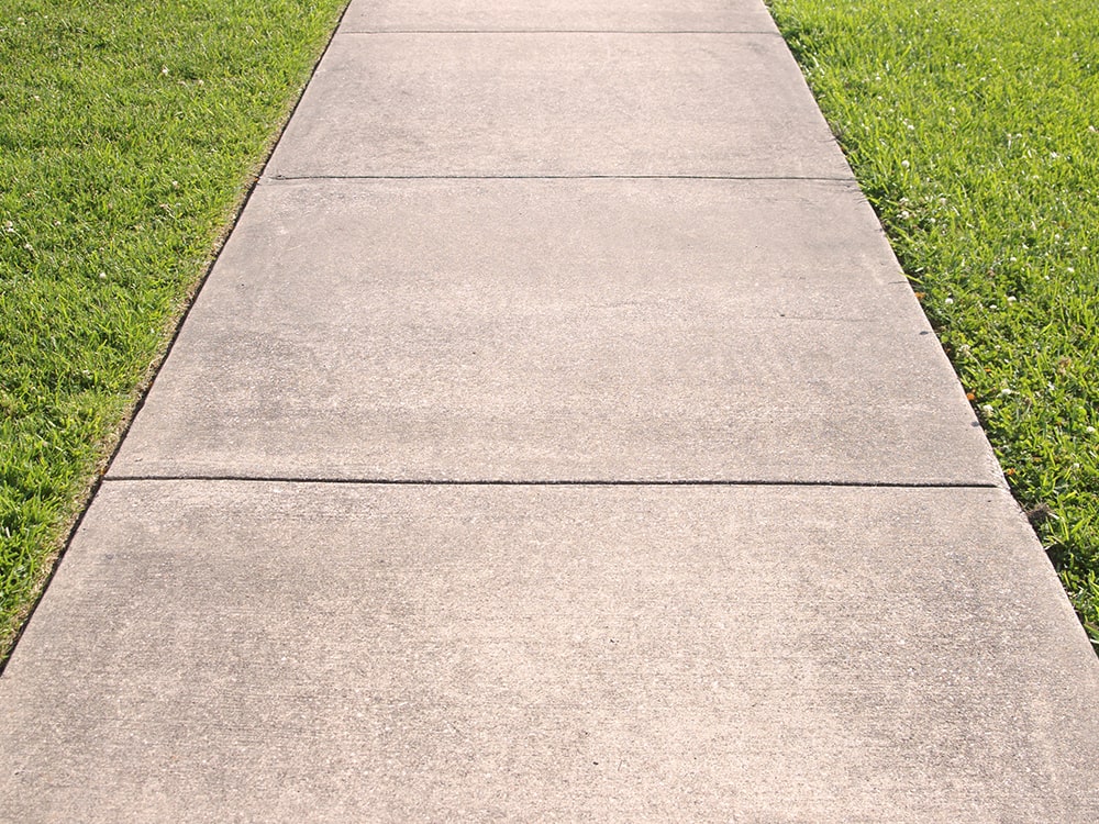 Concrete sidewalk leveled out by mudjacking